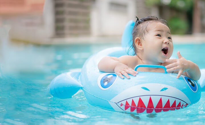 Baby swimming in float